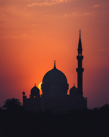 A beautiful mosque silhouette against a warm sunset sky. Perfect for spiritual themes, Ramadan promotions, and Eid celebrations.の素材