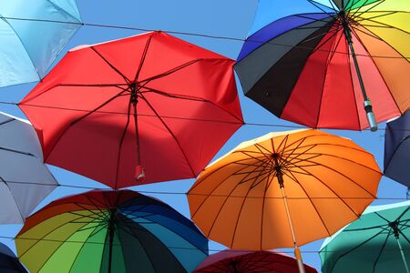 Under a rainbow of umbrellas. Soaring in the sky multi-colored umbrellas.の写真素材