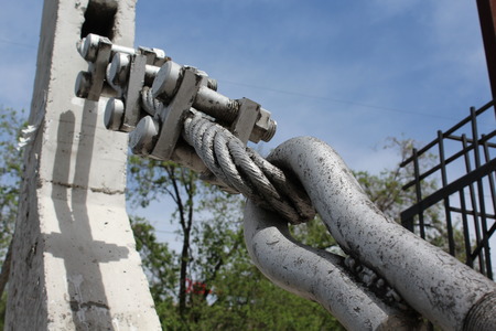 Large bolts, nuts and steel wire rope. Elements of fastening of bridge.の写真素材