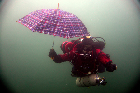 Scuba diver with umbrellaのeditorial素材