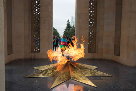 Baku - Azerbaijan: 10 November 2020. Alley of Martyrs cemetery and memorial in Baku. People taking pictures in front of the martyrs monumentのeditorial素材