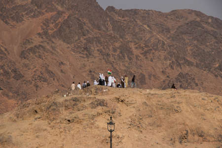 Medina, Saudi Arabia - September 2018: Muslim pilgrims visiting The Martyrs of Uhud at Mount Uhud during umrah season. Archers hillのeditorial素材
