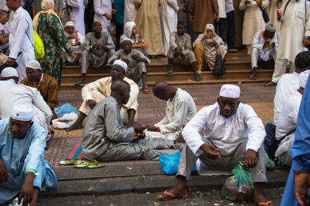 Mecca - Saudi Arabia: 24 August 2018. People eating street food in Mecca. African pilgrims in the...