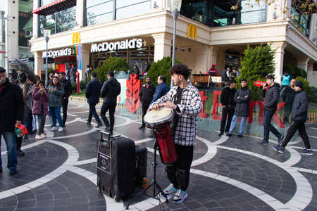 Street Drummer in central square of Baku - Azerbaijan: 31 December 2021. A street musician plays...