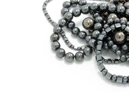 Heap of differently shaped jet coal beads isolatedの写真素材