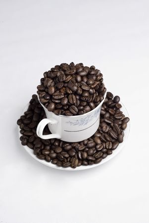 Cup of coffee beans on white backgroundの写真素材