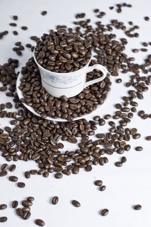 Cup of coffee beans on white backgroundの写真素材