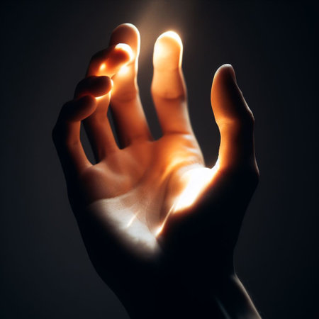 Human hand on dark background, close-up. Conceptual imageの素材