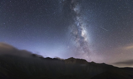 Milky way over the mountains at night. Long exposure photograph.の写真素材