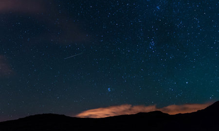 Night sky with stars and a milky way. Long exposure photograph.