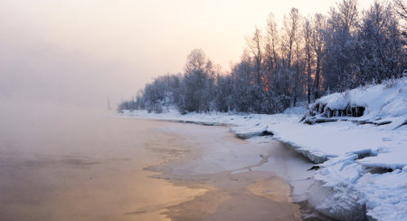 Winter landscape with river and trees in hoarfrost on the shore