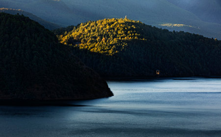 Landscape view of a lake with mountains in the background at sunset