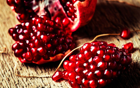 Ripe pomegranate fruit on a wooden background. tinting. selective focusの写真素材