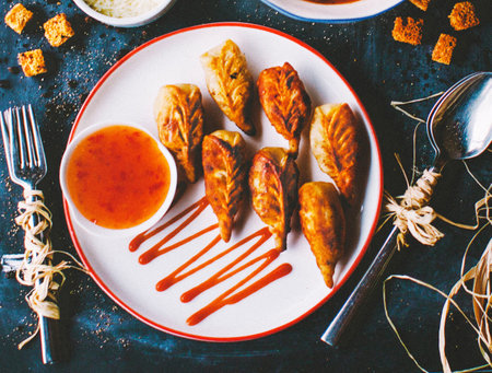 Fried spring rolls with sweet and sour sauce on a plate.