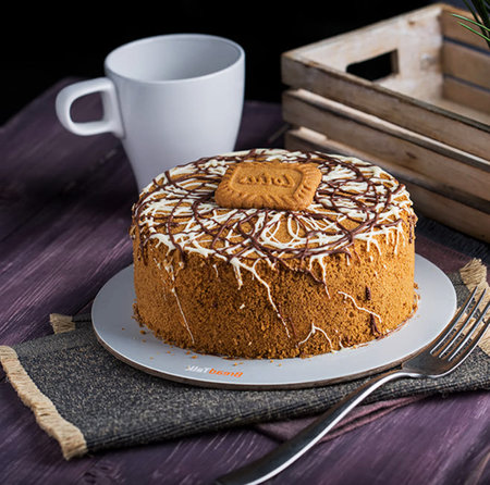 Coffee cake with chocolate glaze on a wooden background.