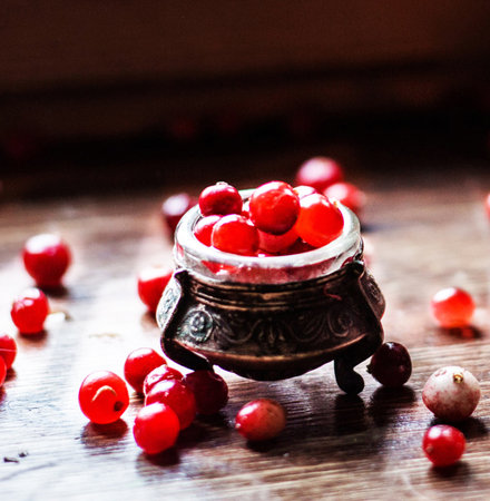 Fresh red cranberries in a rustic jar on a wooden table