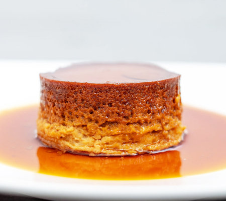 close up of a creme caramel cake on a white plate.の写真素材