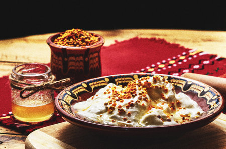 Meringue with honey in a bowl on a wooden table.の写真素材
