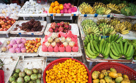 Variety of fruits and vegetables on a market stall.の写真素材