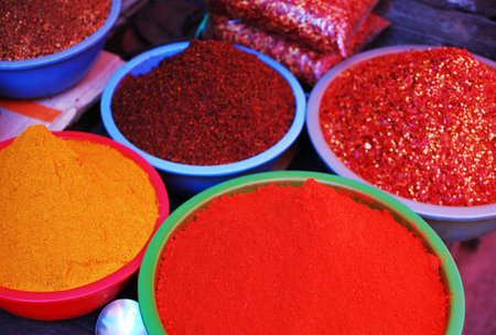 Colorful spices in bowls at a market in India, Asia.