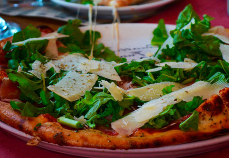 Pizza with mozzarella, arugula and parmesan