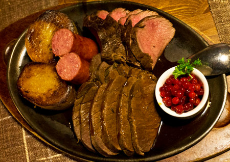 Slices of roast beef with red caviar on a plateの写真素材