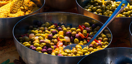 assortment of olives in metal bowl on a market in Indiaの写真素材