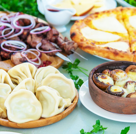 meat dumplings with meat and vegetables on a table in the gardenの写真素材