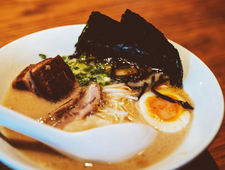 Japanese ramen noodle soup with pork and egg on wood tableの写真素材