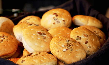 Bread buns with sesame seeds on the table in a bakery