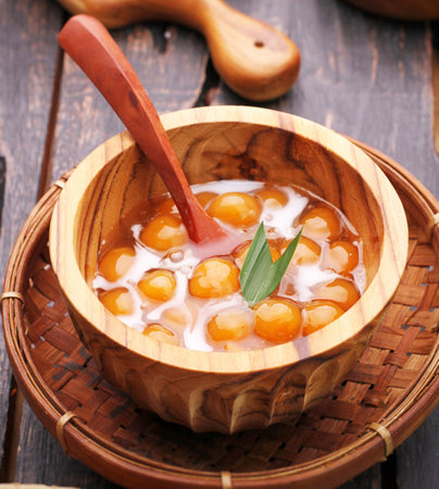 Dessert made from egg yolk and sugar in wooden bowlの写真素材