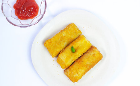 Crispy fried spring rolls with tomato sauce on white plate.