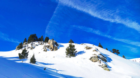 Beautiful winter alpine landscape with snow covered trees and blue sky