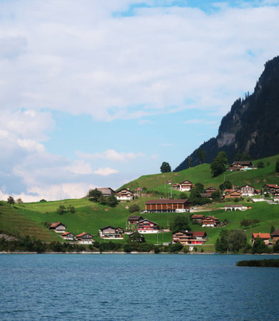 Lake Lucerne, Switzerland, with houses and mountains in the backgroundの写真素材