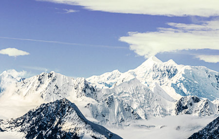 Snowy mountains in the clouds. Caucasus, Dombay.の写真素材