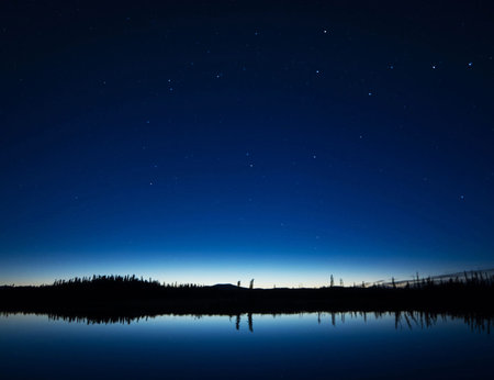 Night landscape with starry sky over the lake. Long exposure.の写真素材