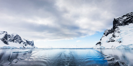 Antarctic landscape with icebergs and ice floes in the ocean