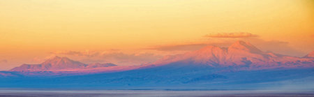 Panoramic view of the snowy mountains at sunset. Iceland.