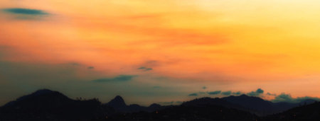 Panoramic view of the sunset over the mountains and the city