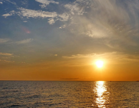 Beautiful sunset over the sea. The sun goes down over the sea.の写真素材