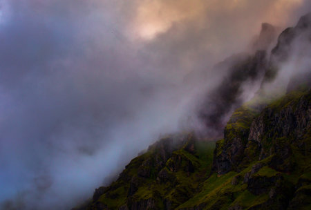 Mountain landscape with fog and clouds at sunset. Caucasus, Russiaの写真素材