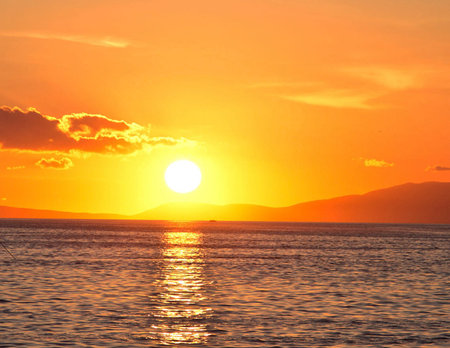 Beautiful sunset over the sea. Sunset over the sea. The sun sets over the sea.の写真素材