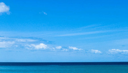 blue sky and white clouds over the calm sea, summer background.の写真素材