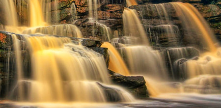 Waterfall in the forest, soft focus, long exposure shot.