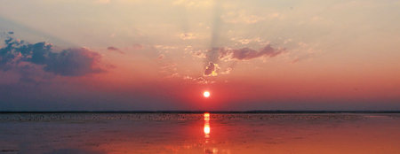Beautiful sunset over the sea. Panoramic view of the sea at sunset.