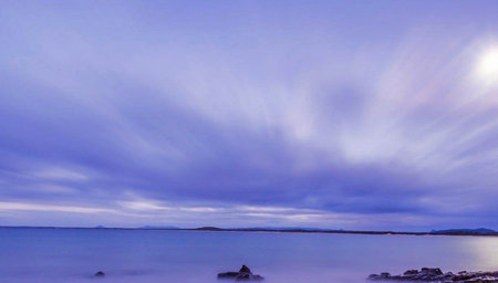 Long exposure seascape with beautiful blue sky and clouds at sunsetの写真素材