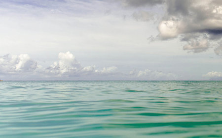 Tropical beach with clear turquoise water and cloudy skyの写真素材