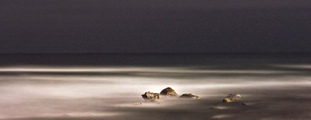 Long exposure of rocks in the sea at night. Long exposure.の写真素材