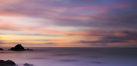 Long exposure of the sea and rock at sunset in the evening.