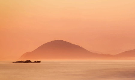 Sunset over the sea and mountains in the background, Thailand.の写真素材